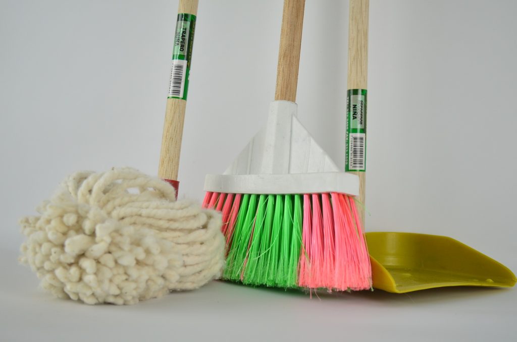 Mop, broom, and dustpan used for cleaning epoxy floors.